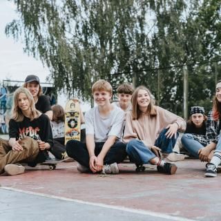 A group of children and young people smiling on a sports court