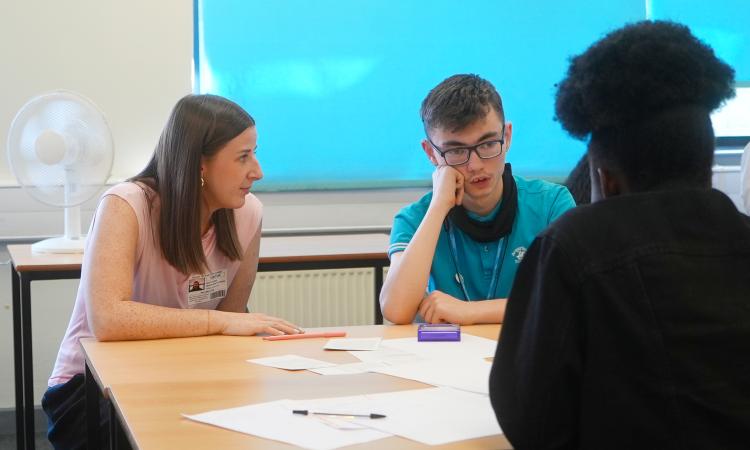 A UOK? trainer talks to students during a workshop