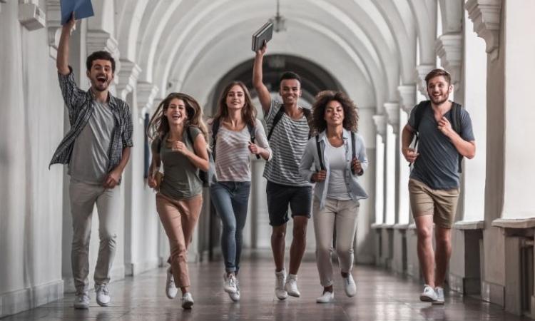 Students celebrating with hands in the air
