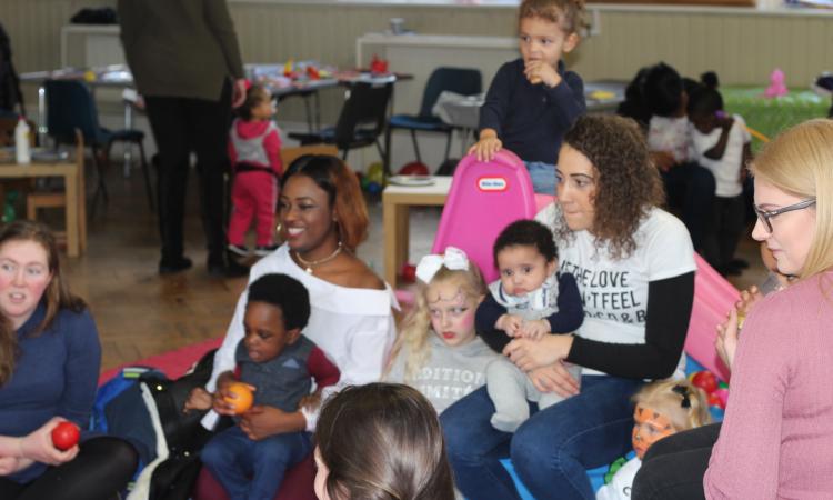 Young mums and babies in a room