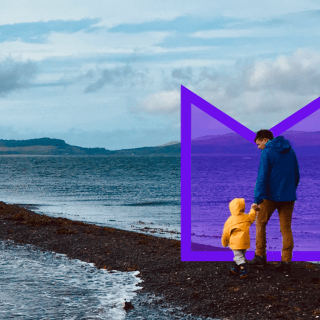 A man and young child walking on the beach. They're highlighted by an M-shaped purple graphic.